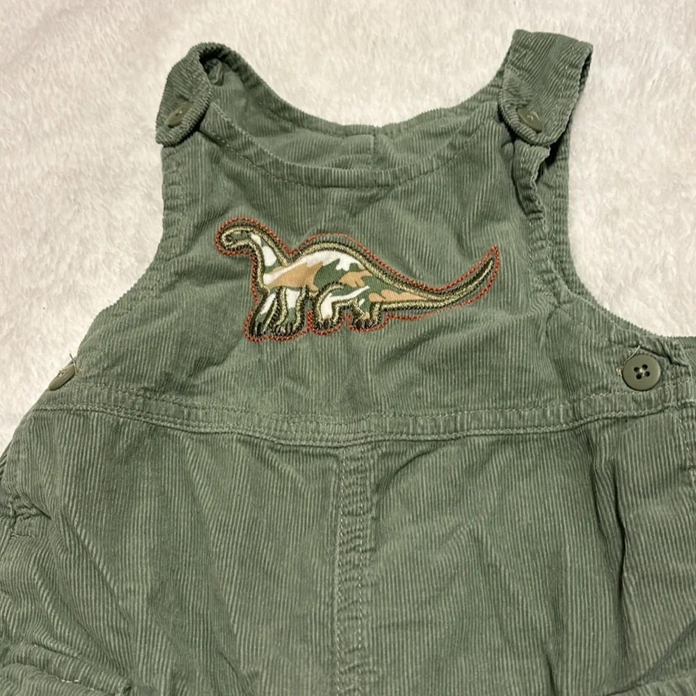 Adorable green dinosaur coveralls overalls with easy buttons. Pair with a onesie